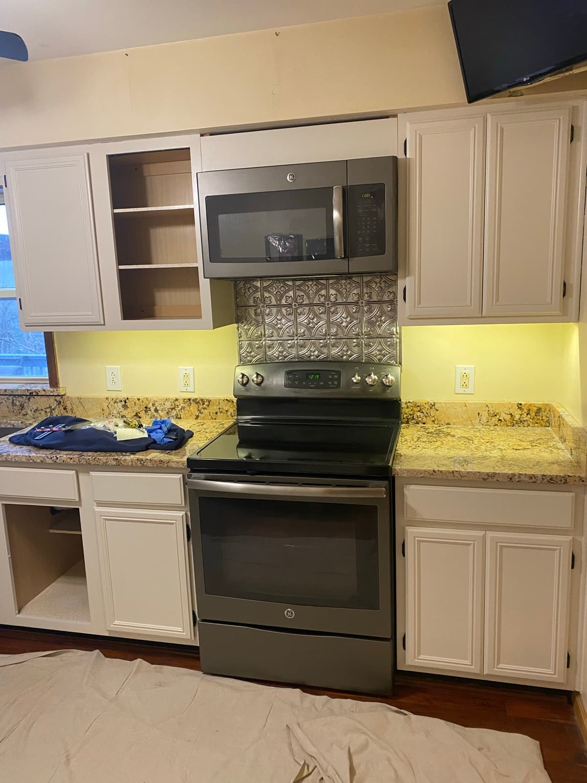 The same kitchen after on-site cabinet refinishing in white