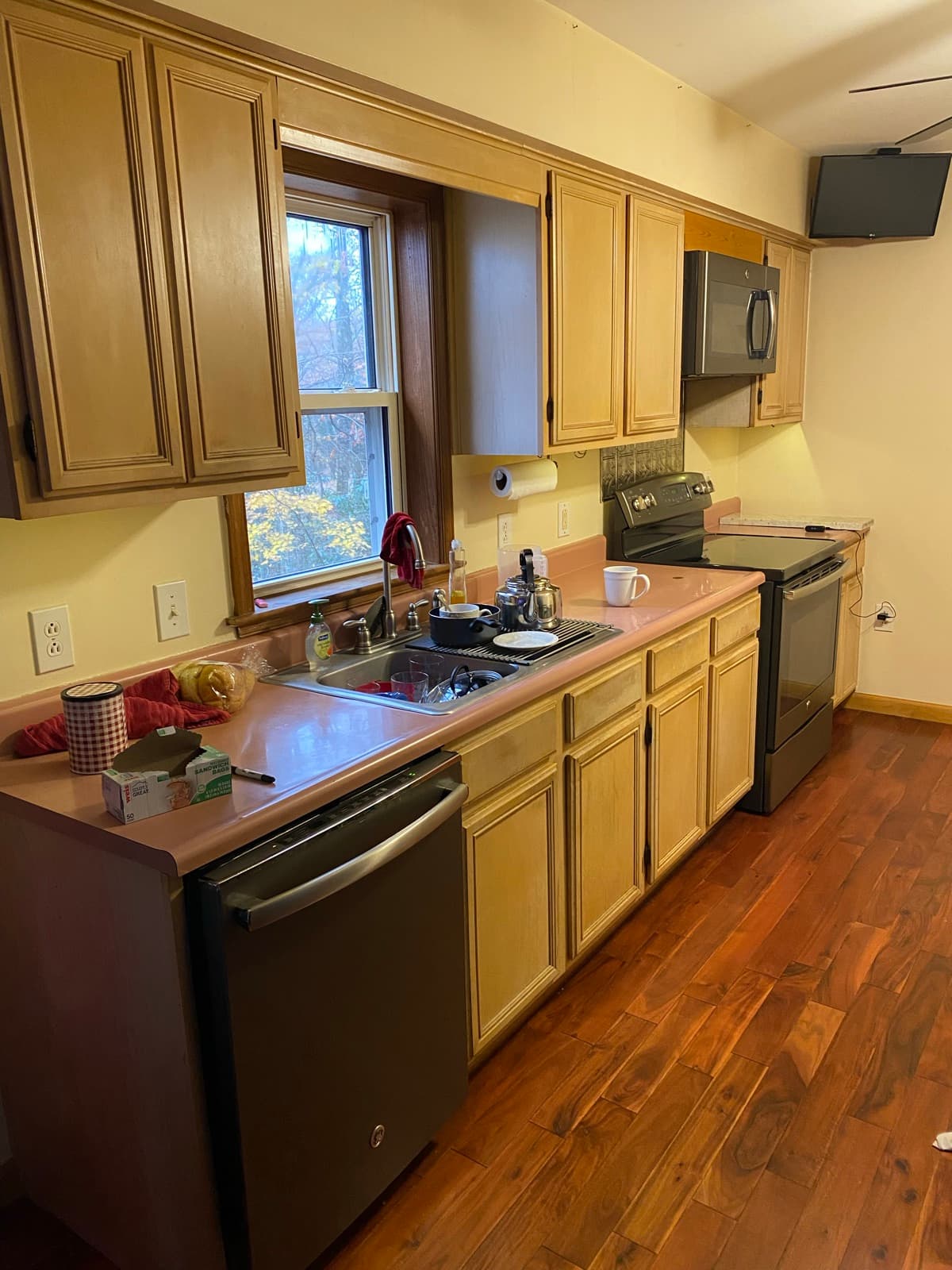Oak kitchen cabinets before an on-site refinishing project