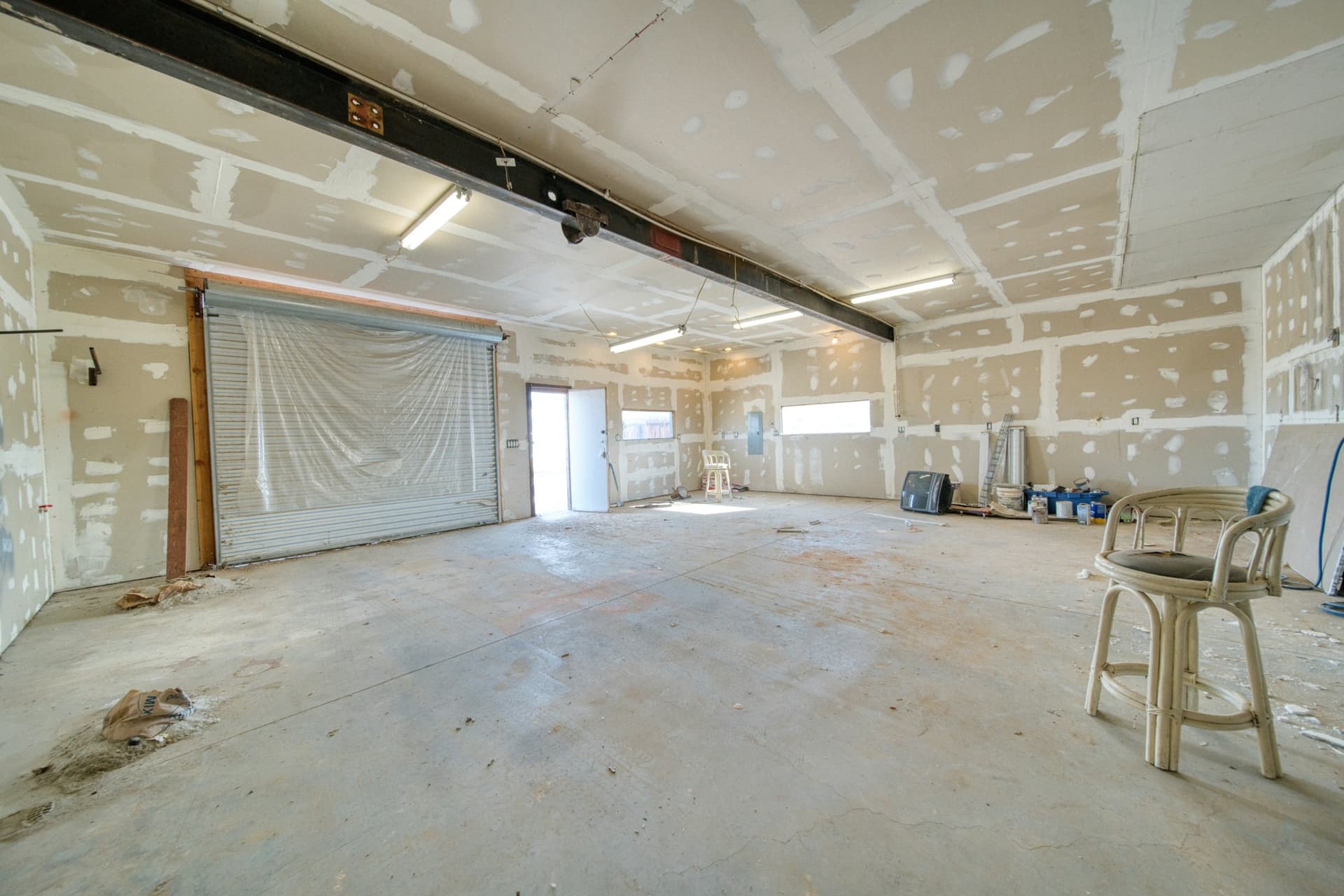 Large interior with newly installed and taped drywall